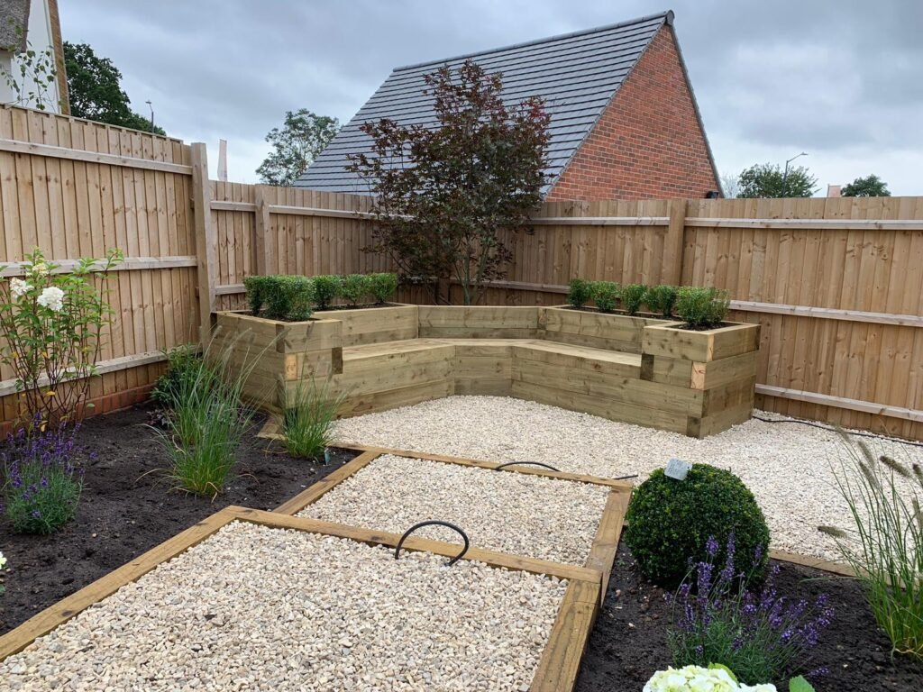 Bespoke timber sleeper seating area and low-maintenance gravel courtyard design built by professional landscapers