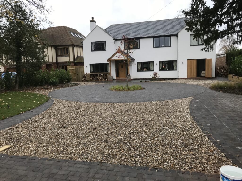 TLD Developments Residential Landscaping Project in Stratford Upon Avon - Stone drive ways, showcase centre tree planted, Log store and planting beds. Lighting in driveway.