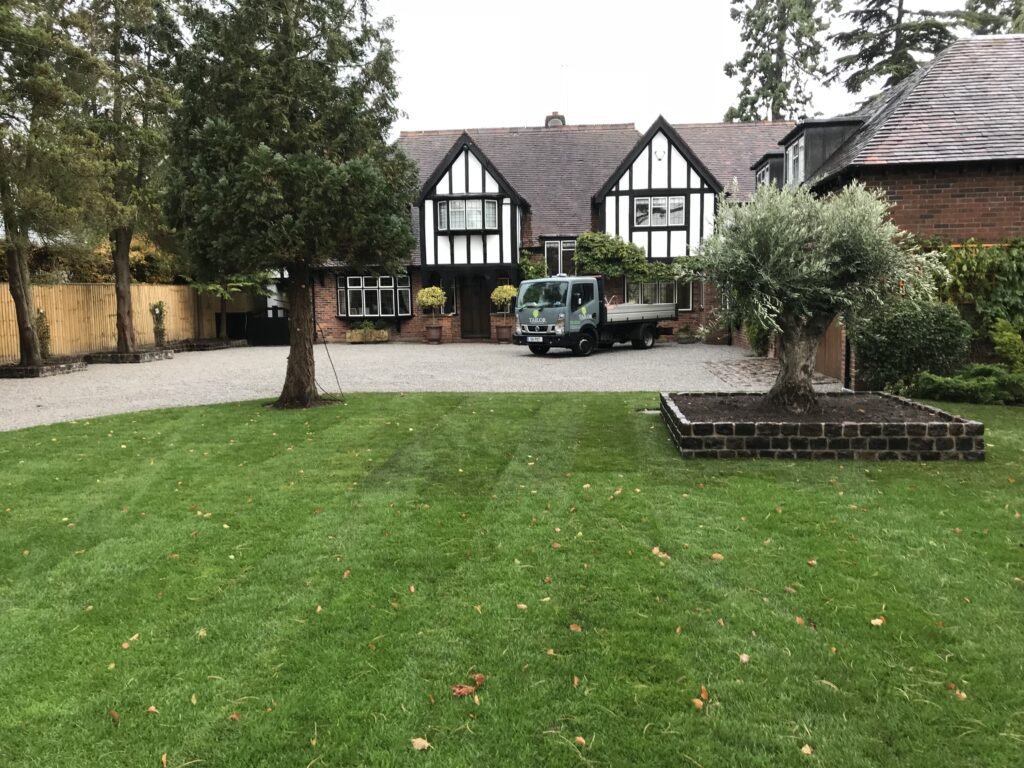 Taylor Landscape and Design Luxury Residential Landscaping Project in Warwickshire - Planting beds, stone and brick driveway, olive tree plant bed raised with bricks and top soil, new lawn.