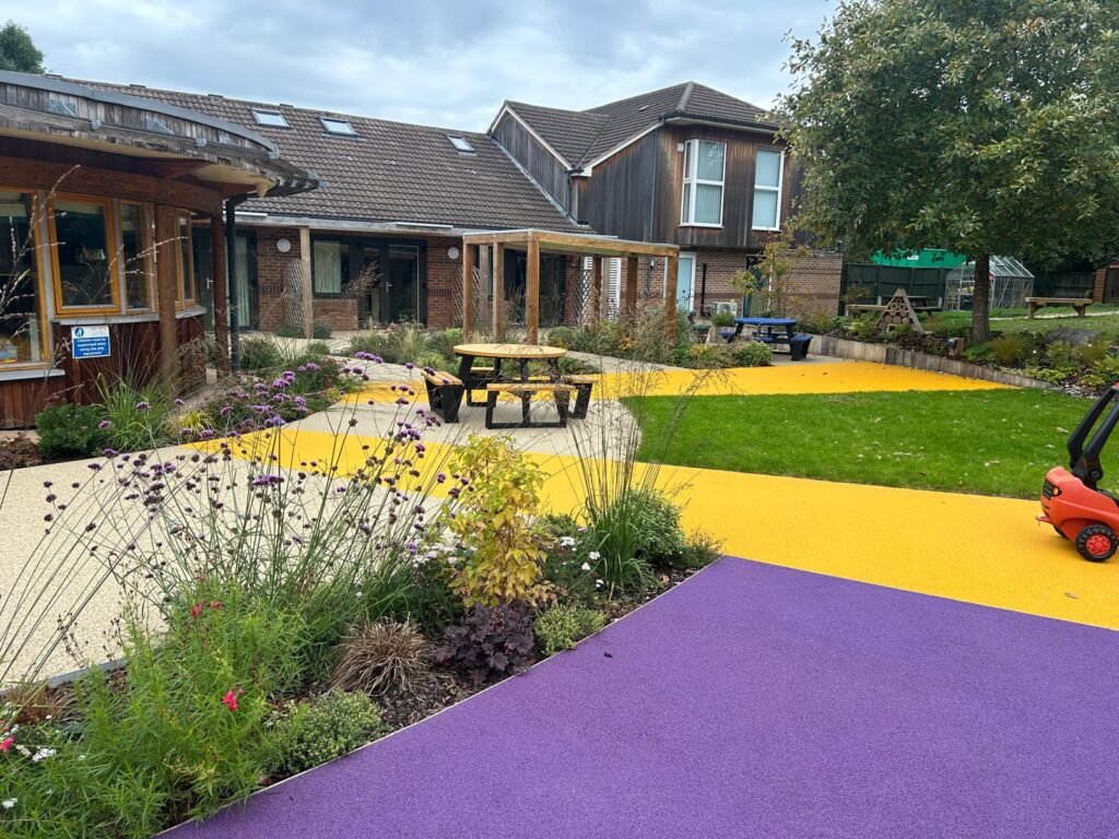 Acorn Hospice in Walsall Commercial Landscaping ProjectResin footpaths, wooden garden structure, outdoor pergola, climbing frames, new turf. New planting plan and flower beds. Stone paths way and patios.