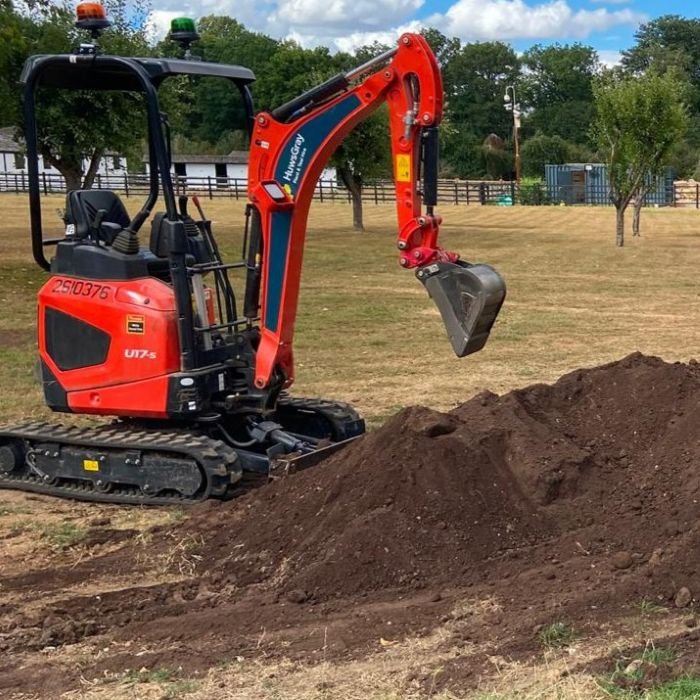 Digger next to pile of topsoil in lapworth Warwickshire