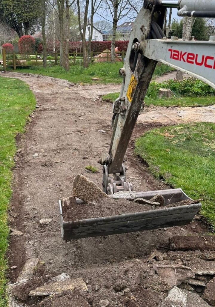 Professional landscape groundworks showing site excavation and sub-base preparation for private estate pathways