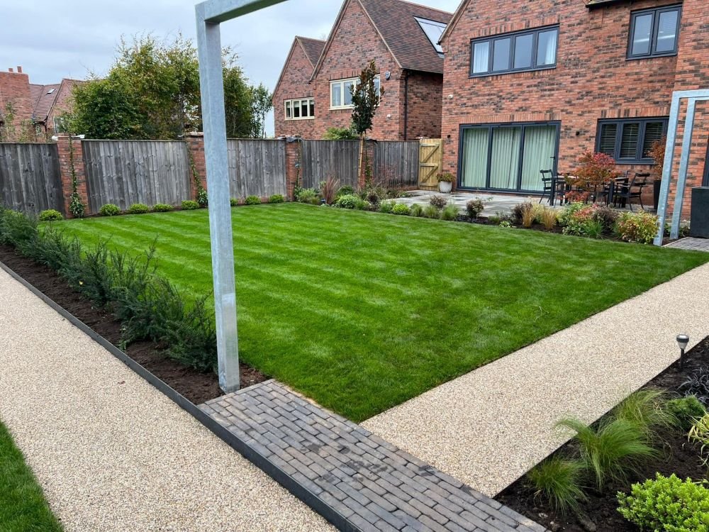 New turf laid with resin pathway, block paving boarder and steel bordered planting beds yew trees