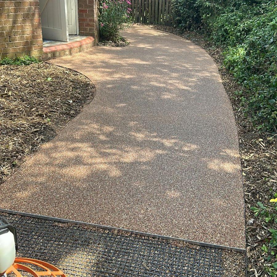 Permeable resin bound pathway installation featuring durable plastic eco-grid base preparation and clean steel edging
