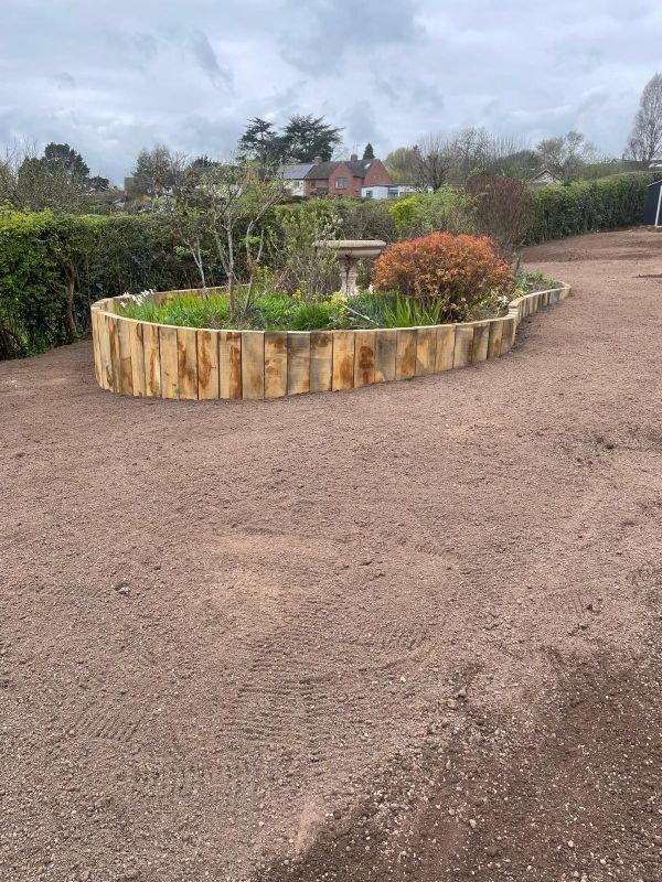 Turf prep being done before turf is laid in Claverdon, train sleeper flower bed