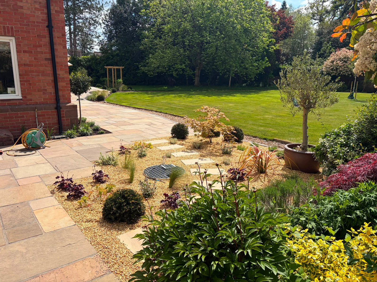 garden re-design where we replaced fencing, made a gate, built a pool, porcelain patio, slabbed patio, planting trees and 200+ other plants, path creation, bbq area created, slopes re-graded and seeded, birch tress planted, custom garden lighting