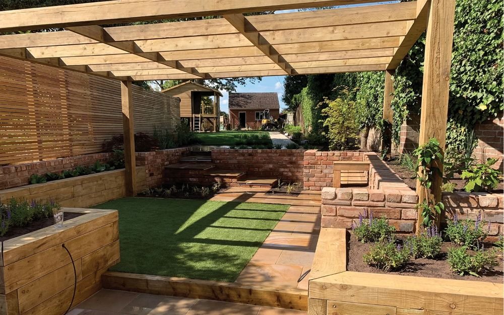 Hard and soft landscaping, bbq area, train sleepers, turf and retaining walls