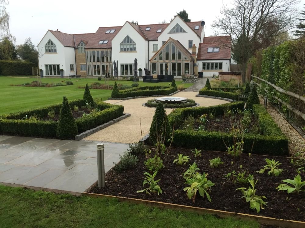 Large residential property landscaping pathway planting beds and decretive hedges